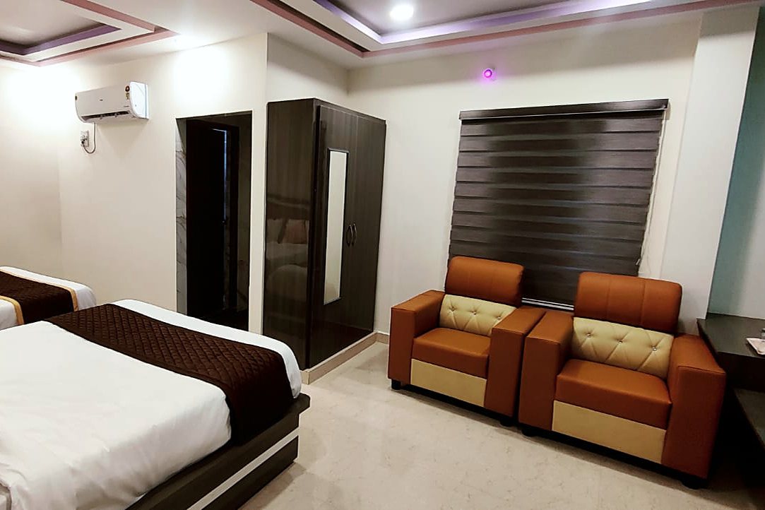 Suite Room sitting area with sofa chairs, wardrobe and window