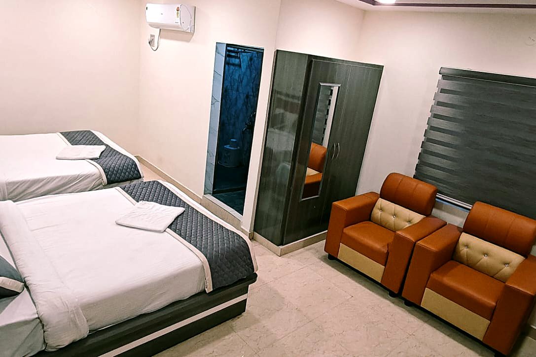 Suite Room with two beds and sofa chairs